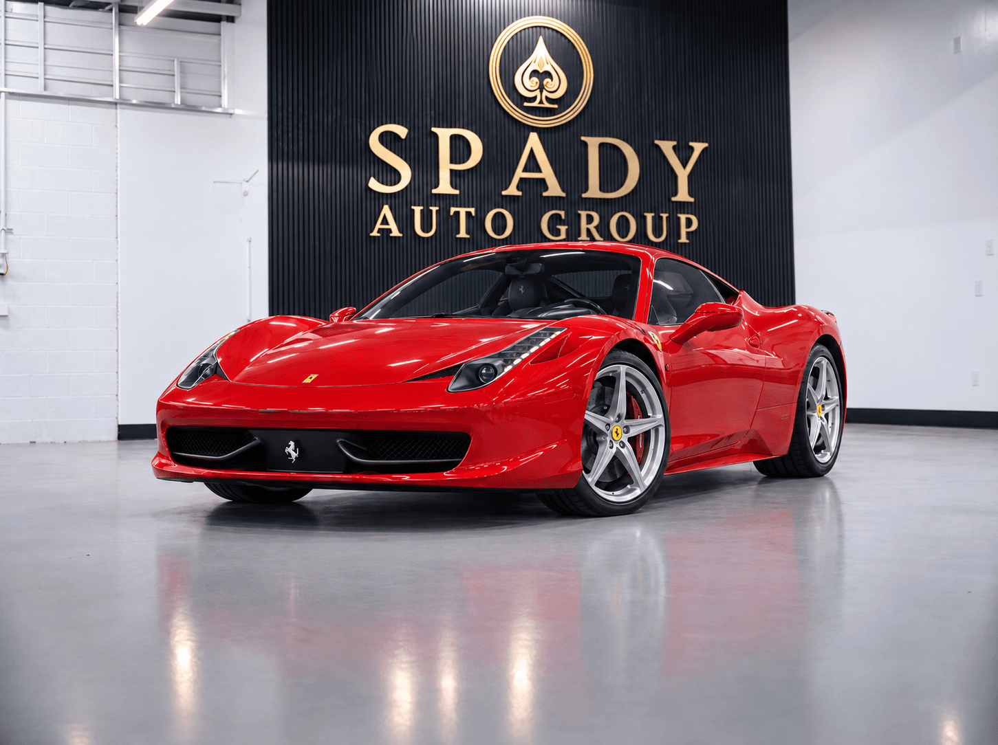 Illustration of a red Ferrari 458 Italia in the Spady showroom beneath the gold Spady Auto Group sign and spade emblem.